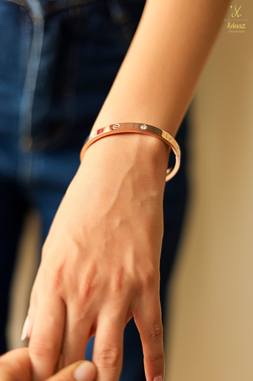 "Timeless Gold Cuff and Chain Bracelet Duo."